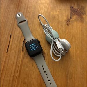 Apple Smartwatch with Black Display and Cream Band